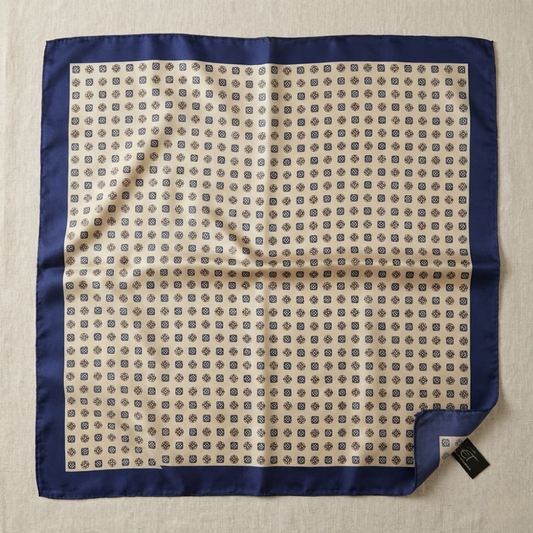 Patterned square scarf with blue border on a beige background