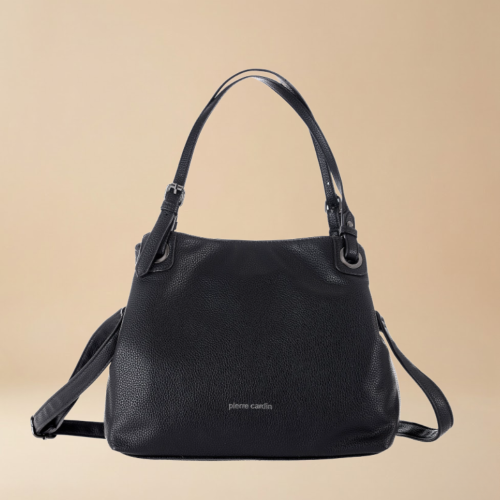 A black pebbled leather handbag by Pierre Cardin with dual top handles and a detachable shoulder strap, shown against a solid beige background.