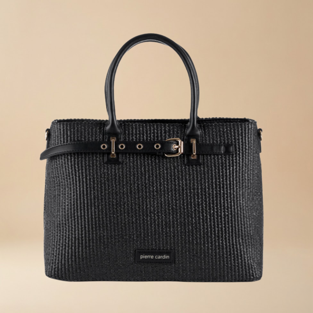 Black woven handbag with leather handles on a beige background