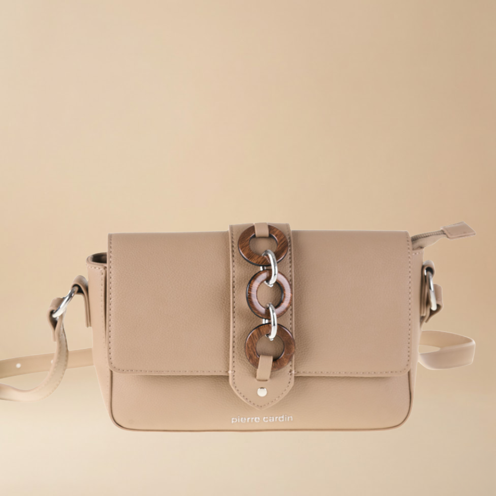 Beige handbag with a decorative strap on a beige background