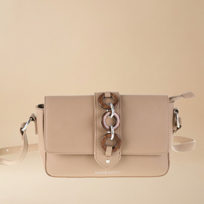 Beige handbag with a decorative strap on a beige background
