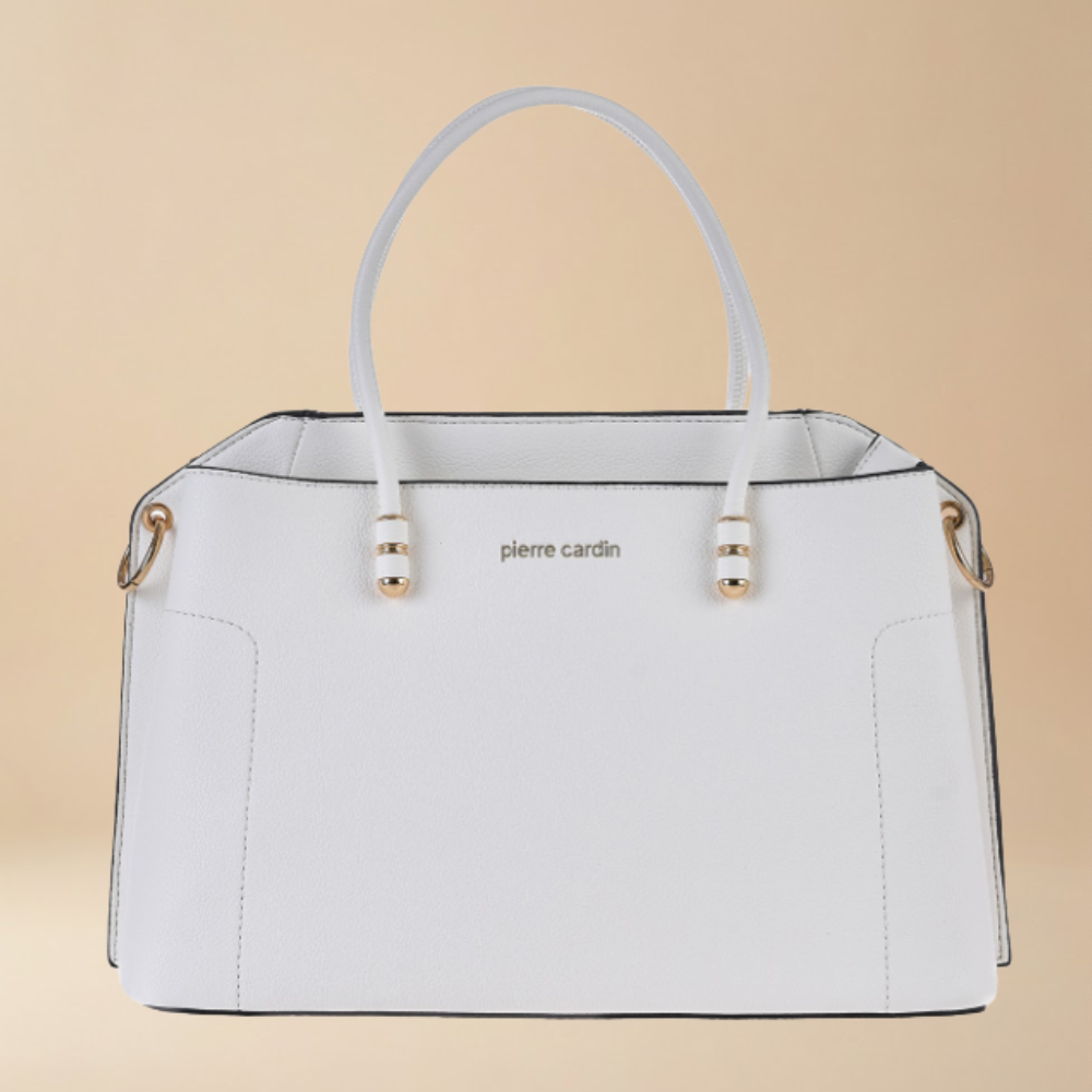 White handbag with gold accents on a beige background