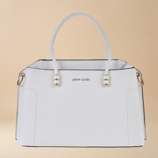 White handbag with gold accents on a beige background